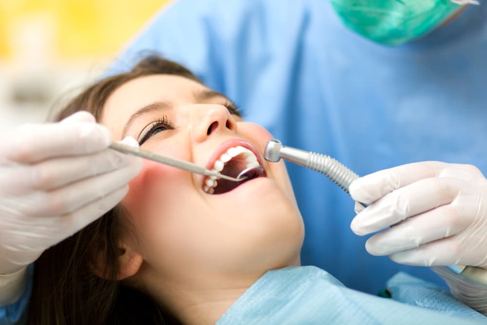 Female patient being treated by a dentist